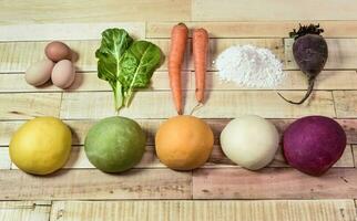 Colored dough buns for pasta, with ingredients on the table. photo