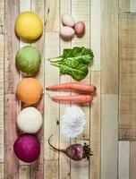 Colored dough buns for pasta, with ingredients on the table. photo