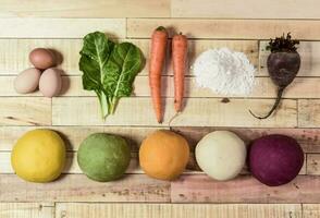 Colored dough buns for pasta, with ingredients on the table. photo