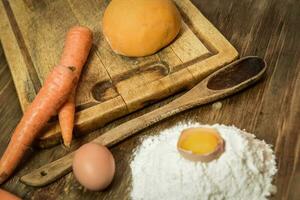 Orange dough bun for noodles with ingredients on the table. photo