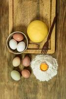 Egg noodle dough bun, with ingredients on the table. photo