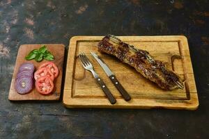 Roasted beef ribs presented on the table, Patagonia, Argentina. photo