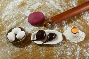 Purple dough bun for noodles with ingredients on the table. photo
