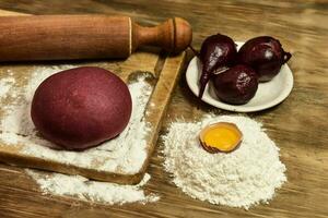 Purple dough bun for noodles with ingredients on the table. photo