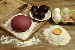 Purple dough bun for noodles with ingredients on the table. photo