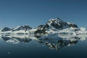 Lemaire strait coast, mountains and icebergs, Antartica photo