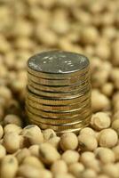 Dollars banknotes and coins and soy beans,oleaginous commoditi value concept. photo