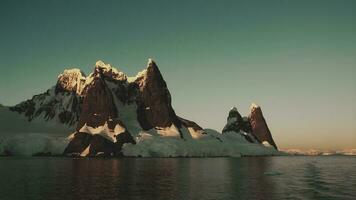 Lemaire strait coastal landscape, mountains and icebergs, Antarctic Peninsula, Antartica. photo