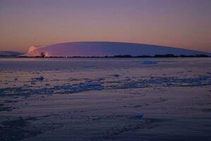 Lemaire strait coastal landscape, mountains and icebergs, Antarctic Peninsula, Antartica. photo