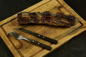 Roasted beef ribs presented on the table, traditional Argentine cuisine, Asado barbecue, Patagonia, Argentina. photo