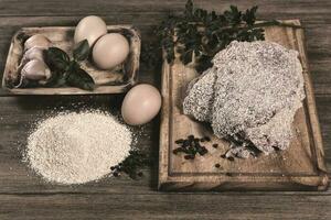 Veal milanese presented on the table with ingredients photo