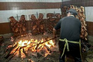 Gaucho roast barbecue, sausage and cow ribs, traditional argentine cuisine, Patagonia, Argentina. photo