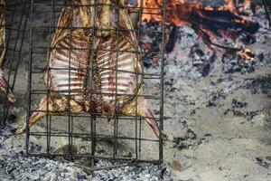 Lamb on the spit, Patagonia, Argentina. photo