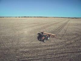 Tractor and seeder, direct sowing in the pampa, Argentina photo