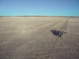 Tractor and seeder, direct sowing in the pampa, Argentina photo