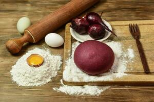 Purple dough bun for noodles with ingredients on the table. photo