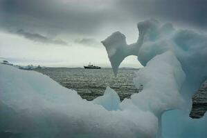 Expedition ship, cruise in Antarctic landscape, Paulet island, near the Antarctic Peninsula photo