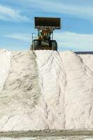 Trucks unloading raw salt bulk, Salinas Grandes de Hidalgo, La Pampa, Argentina. photo