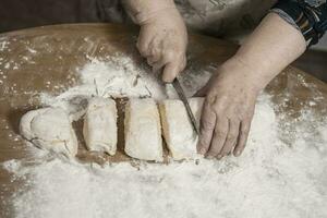 Hands kneading dough for gnocchi. photo