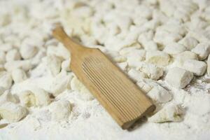 Dough of handmade gnocchi and cooking elements photo