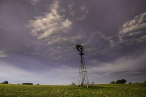 Windmill in countryside at sunset, Pampas, Patagonia,Argentina. photo