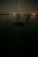 Starry sky reflected in the water, La Pampa Province, Patagonia, Argentina. photo