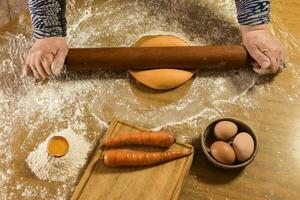 Egg dough for noodles, with ingredients on the table, traditional italian cuisine. photo