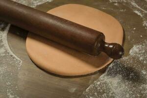 Egg dough for noodles, with ingredients on the table, traditional italian cuisine. photo