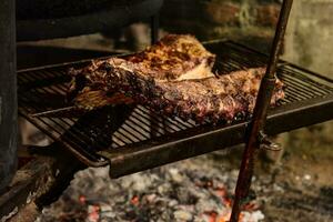 Pork ribs barbecue , Patagonia, Argentina photo