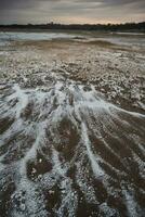 Saltpeter on the floor of a lagoon in a semi desert environment, La Pampa province, Patagonia, Argentina. photo