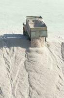 Trucks unloading raw salt bulk, Salinas Grandes de Hidalgo, La Pampa, Argentina. photo