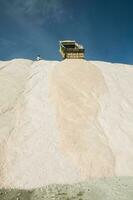 Trucks unloading raw salt bulk, Salinas Grandes de Hidalgo, La Pampa, Argentina. photo