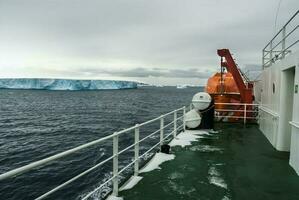 Expedition ship, cruise in Antarctic landscape, Paulet island, near the Antarctic Peninsula photo