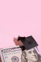 Graduated cap with dollars. Grant for education, back to school allowance concept photo