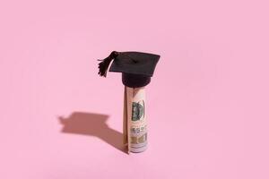 Graduated cap with dollars. Grant for education, back to school allowance concept photo