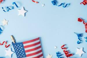 USA Independence day concept. USA flags and Red and blue spirals and white stars top view, flat lay on blue background with copy space photo