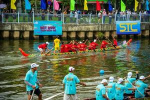 Ho Chi Minh, Viet Nam - 23 April 2023 Blurry motion of boat racing in the traditional Ngo boat racing festival of Khmer people photo