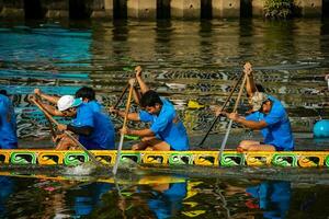 Ho Chi Minh, Viet Nam - 23 April 2023 Blurry motion of boat racing in the traditional Ngo boat racing festival of Khmer people photo