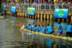 Ho Chi Minh, Viet Nam - 23 April 2023 Blurry motion of boat racing in the traditional Ngo boat racing festival of Khmer people photo