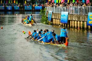 Ho Chi Minh, Viet Nam - 23 April 2023 Blurry motion of boat racing in the traditional Ngo boat racing festival of Khmer people photo