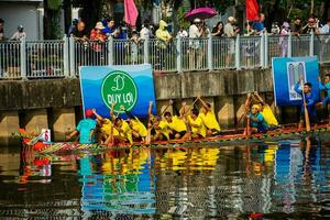 Ho Chi Minh, Viet Nam - 23 April 2023 Blurry motion of boat racing in the traditional Ngo boat racing festival of Khmer people photo