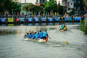 Ho Chi Minh, Viet Nam - 23 April 2023 Blurry motion of boat racing in the traditional Ngo boat racing festival of Khmer people photo