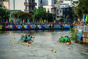 Ho Chi Minh, Viet Nam - 23 April 2023 Blurry motion of boat racing in the traditional Ngo boat racing festival of Khmer people photo