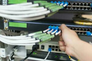 People fix core switch in network room photo