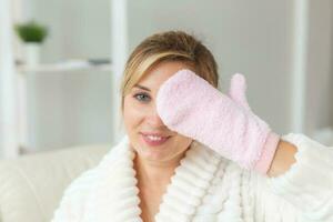 Woman hand holding massage sponge - spa and body care concept photo