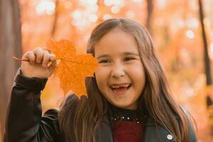 Autumn emotional portrait of laughing child walking in park or forest photo