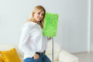 Portrait of housewife woman holds mop pad - cleaning concept photo