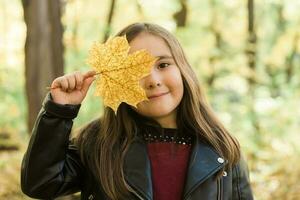 Asian child girl laughing and playing in the autumn on the nature walk outdoors photo