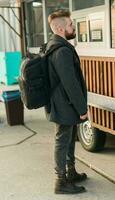 Portrait of man choosing fast food in food truck in the street. Meal, food industry and streetfood concept. photo