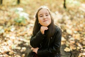 Asian child girl laughing and playing in the autumn on the nature walk outdoors photo